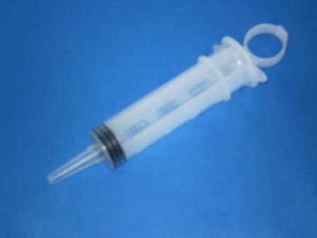 Enteral Irrigation Syringe Piston Type with a tip Syringe adaptor and tip protector in an IV pole ha